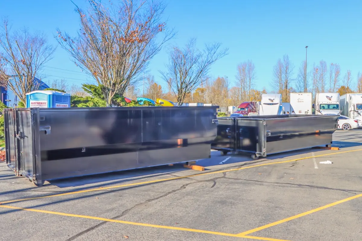 Professional dumpster rental service with roll-off container on residential driveway in Paramus
